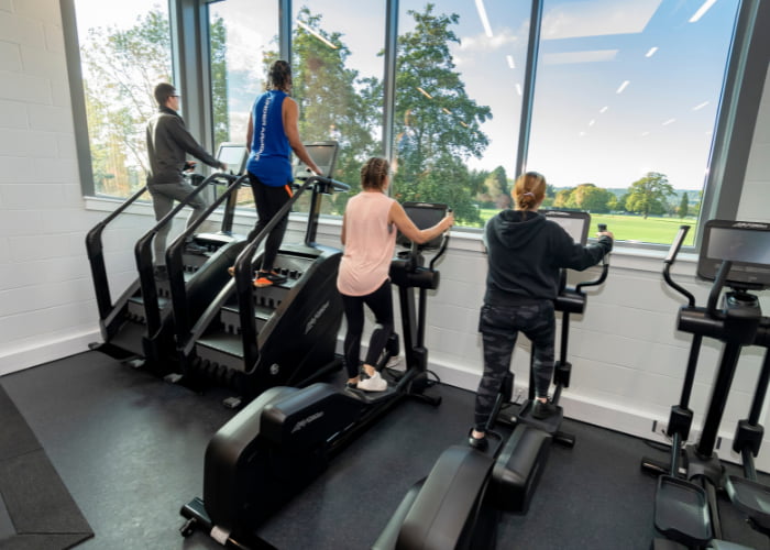GYM People working out on step machines in the gym