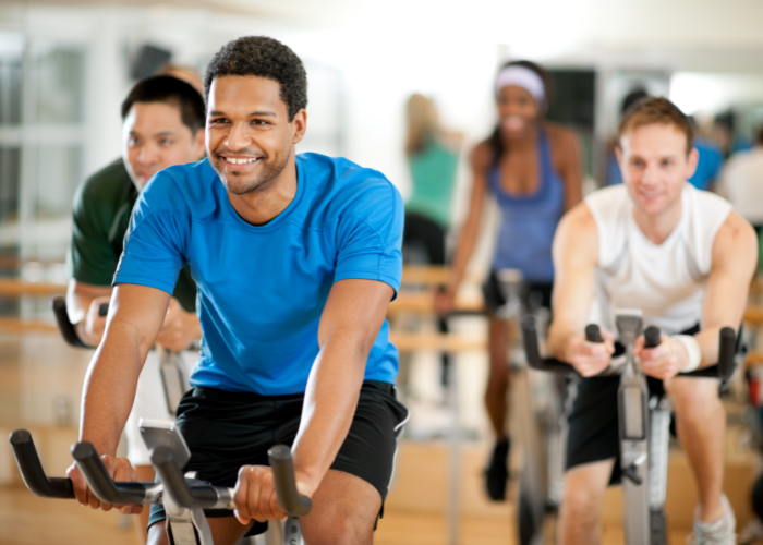 Man cycling on a stationary bike in a group exercise class